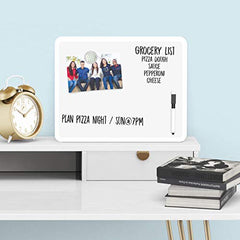 Dry erase board on a desk with books and a clock.